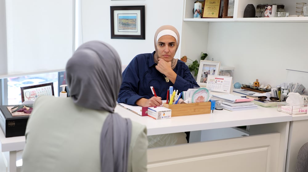 Dr. Jallad engaging with a patient at her clinic.
