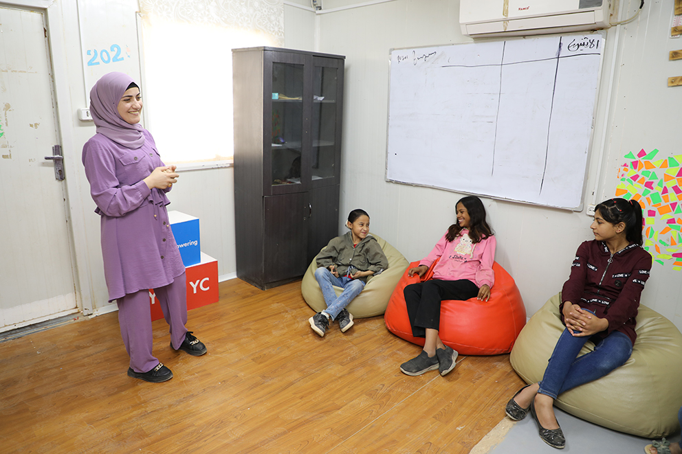 Nour leading an enlightening session on child marriage awareness with adolescent girls at the youth center in Zaatari camp.