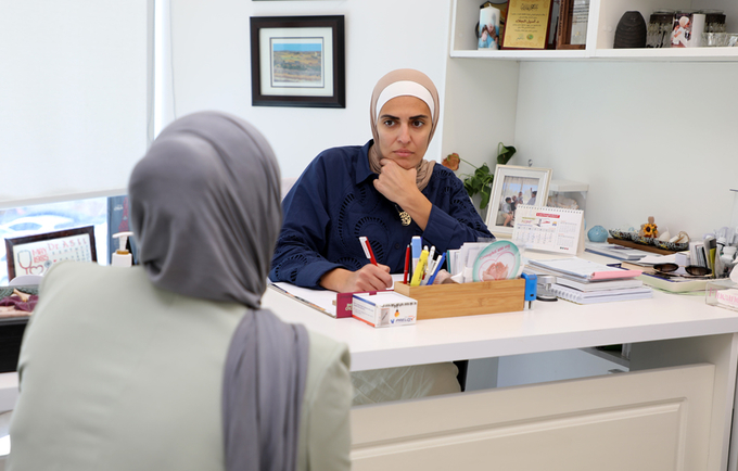 Dr. Jallad engaging with a patient at her clinic.